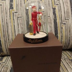 Louis Vuitton bellhop in a globe statue